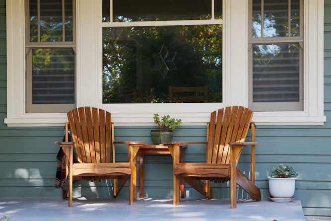 front porch with two chairs and a window
