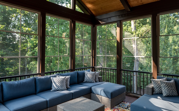 screened in porch with furniture